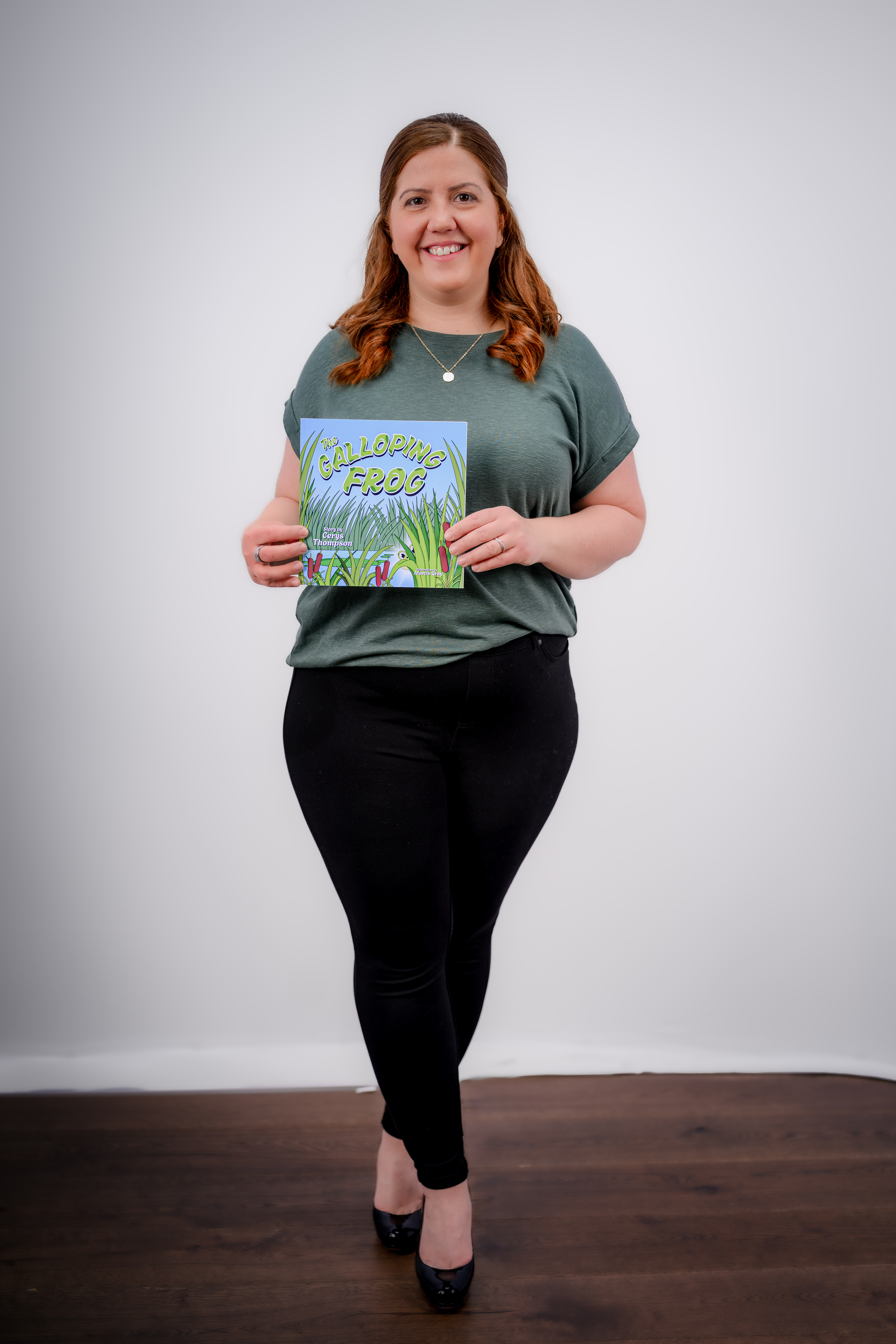 Cerys Thompson holding her children's book, The Galloping Frog