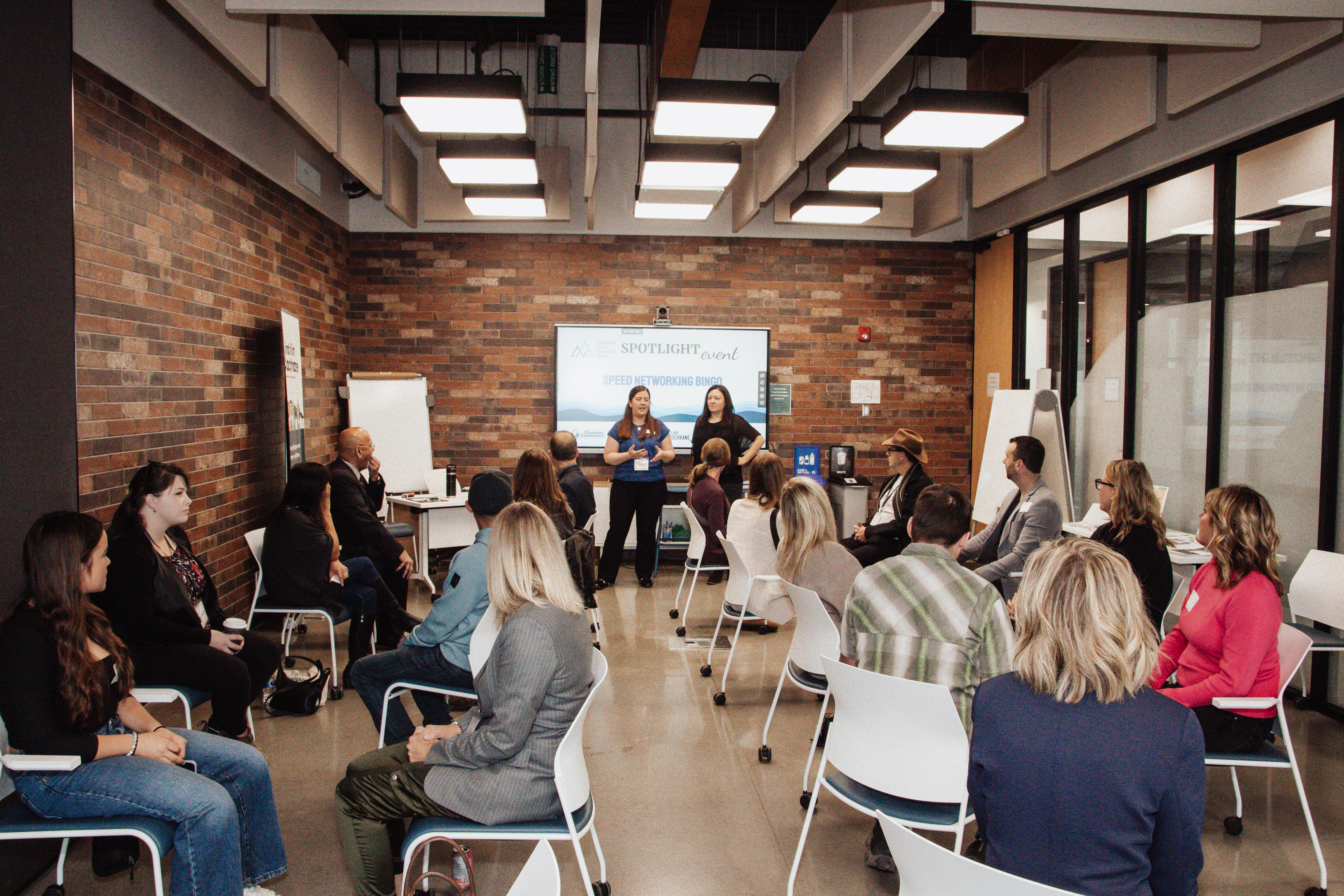 Business owners at a Cochrane Business Network event, with Cerys Thompson standing at the front