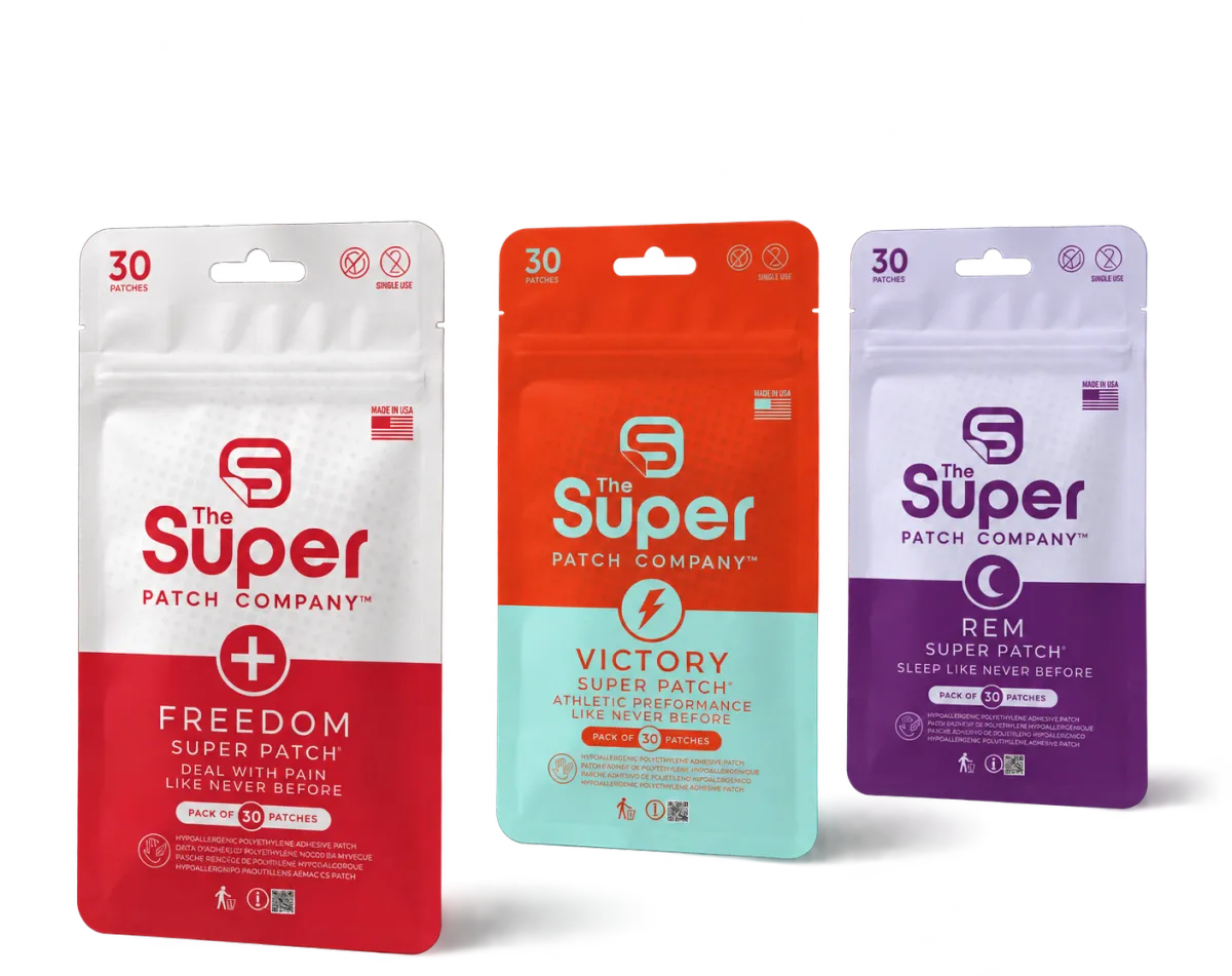 Three pouches of Super Patch products standing side by side. From left to right: a white and red pouch labeled 'FREEDOM', an orange pouch labeled 'VICTORY', and a purple pouch labeled 'REM'.