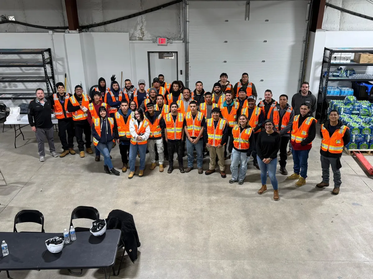 three men laughing while looking in the laptop inside room