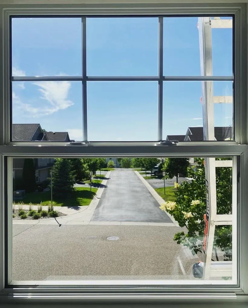 Crystal clear residential windows cleaned by WellDone Windows showing neighborhood view with spotless glass