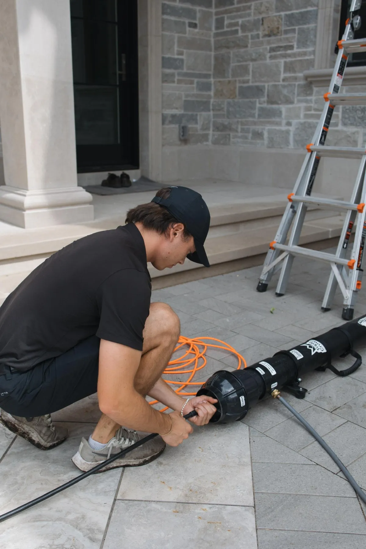 Window cleaning professional using specialized water filtration system for streak-free residential results