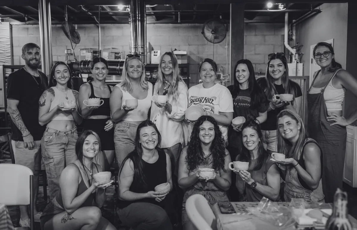 person making clay vase