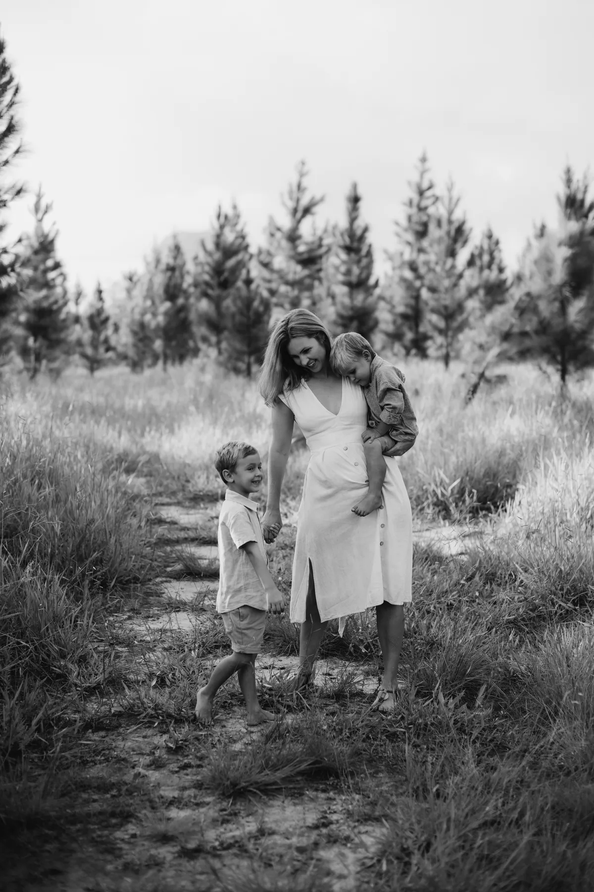 Calm, authentic portrait of a reflective mother in warm natural light