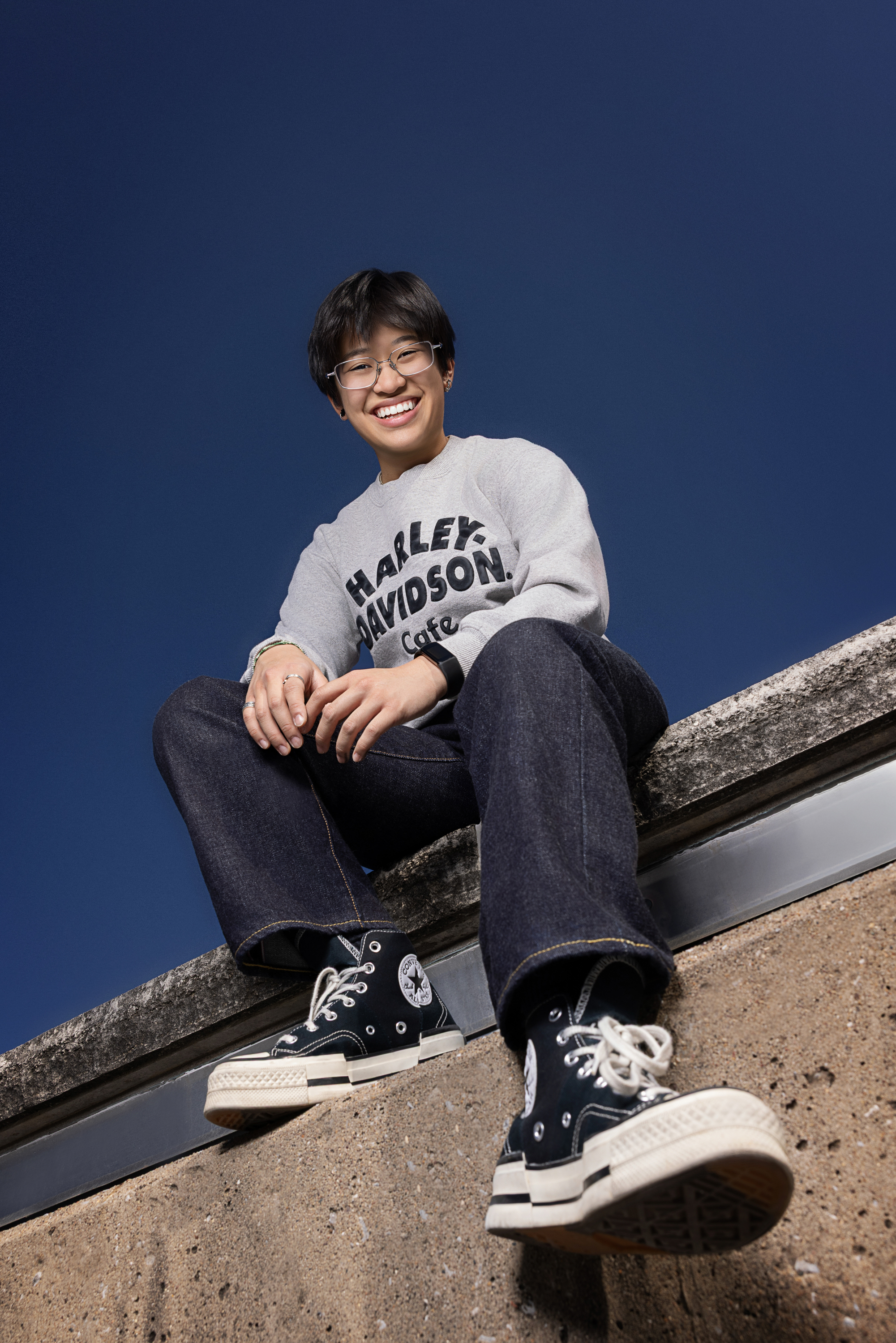 Senior girl twirling in a field during sunset