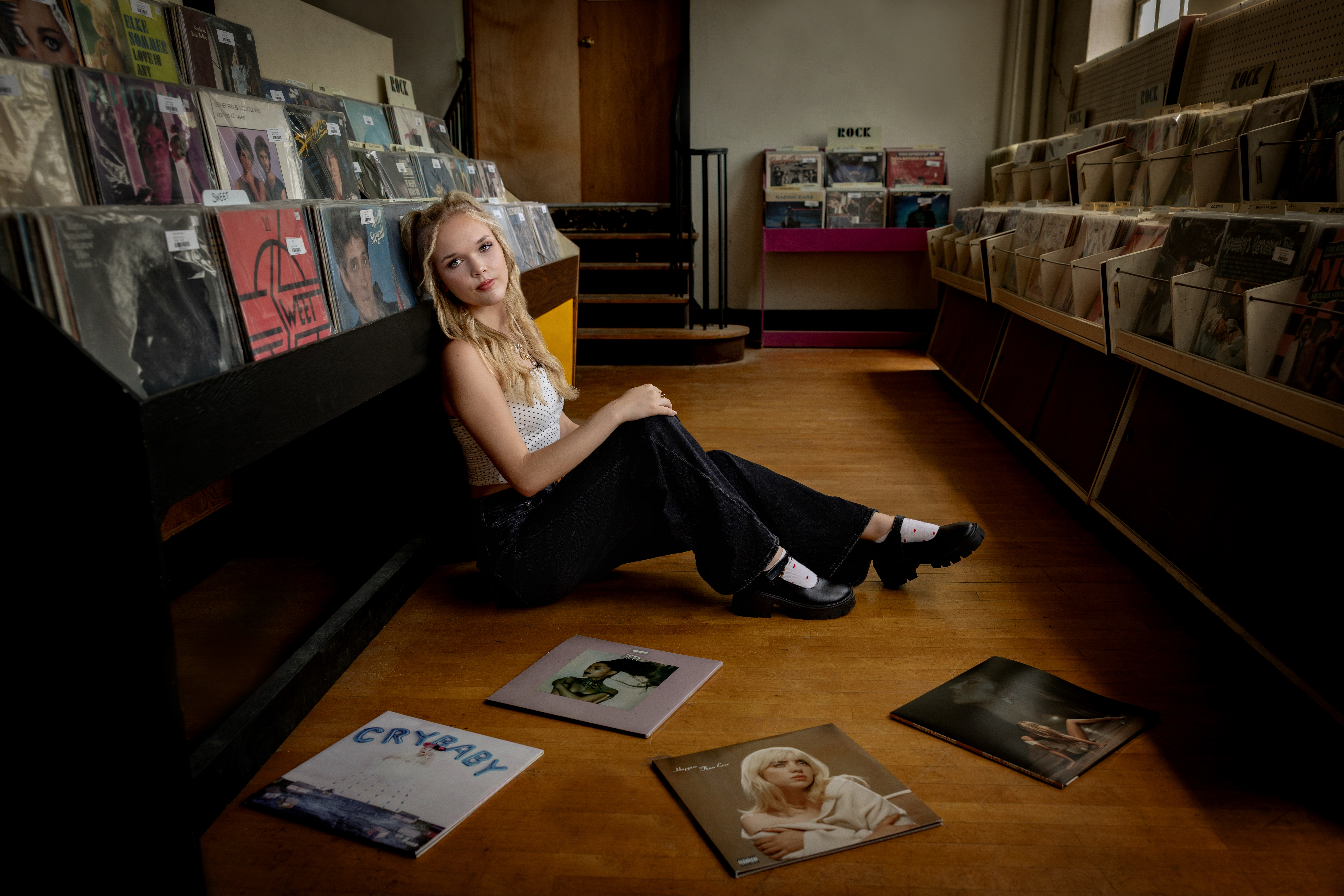 high school senior claudia in a record store looking edgy 
