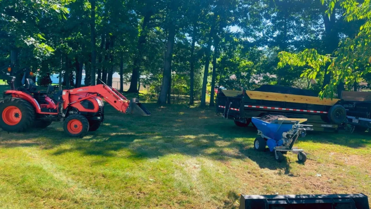 Landscaping tractor and lawn care equipment at a residential property