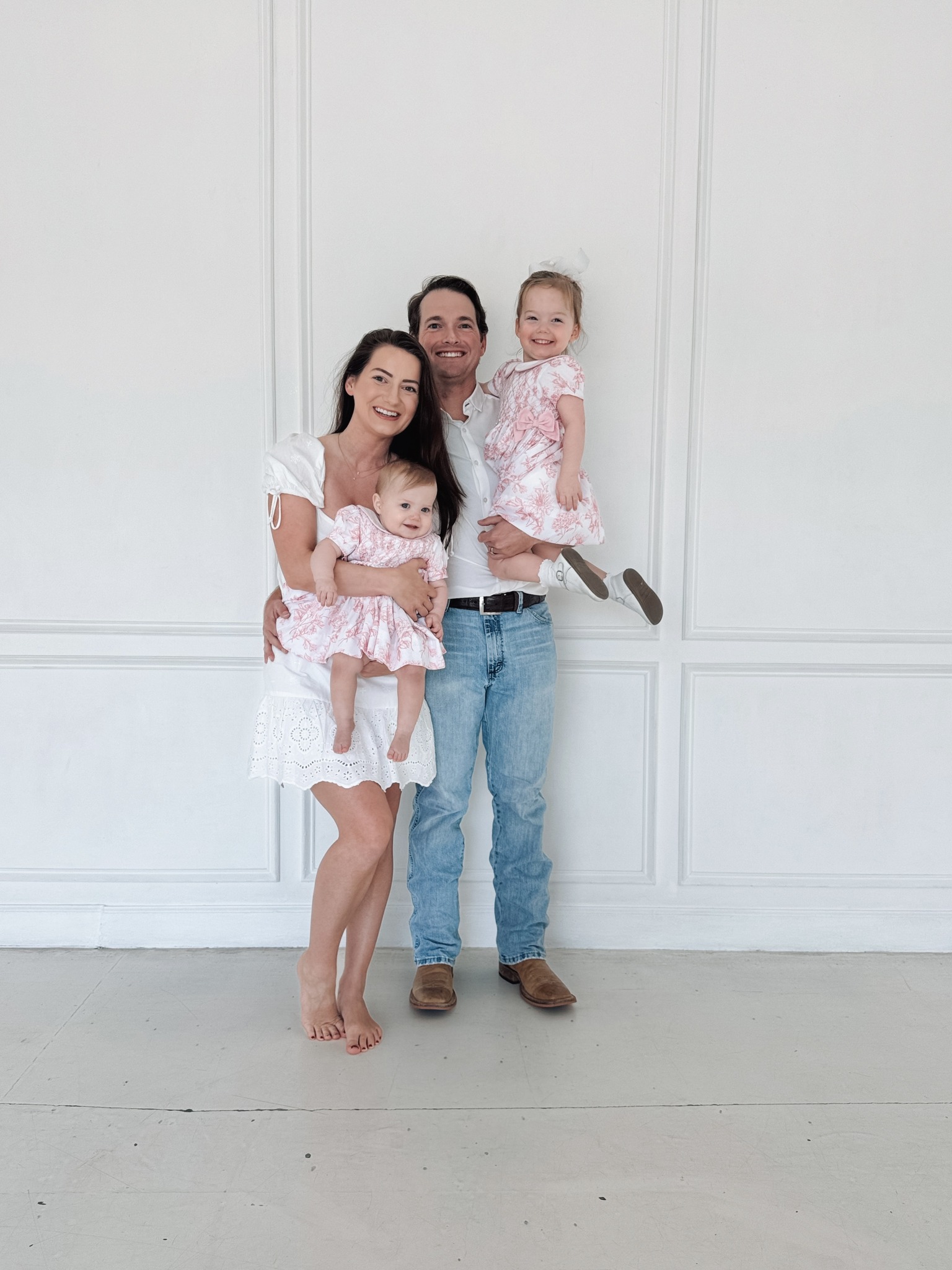 a pregnant woman in a white dress sitting on a chair