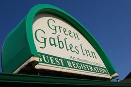 Elegant carved wooden welcome plaque with green pine accent, photorealistic, for masthead