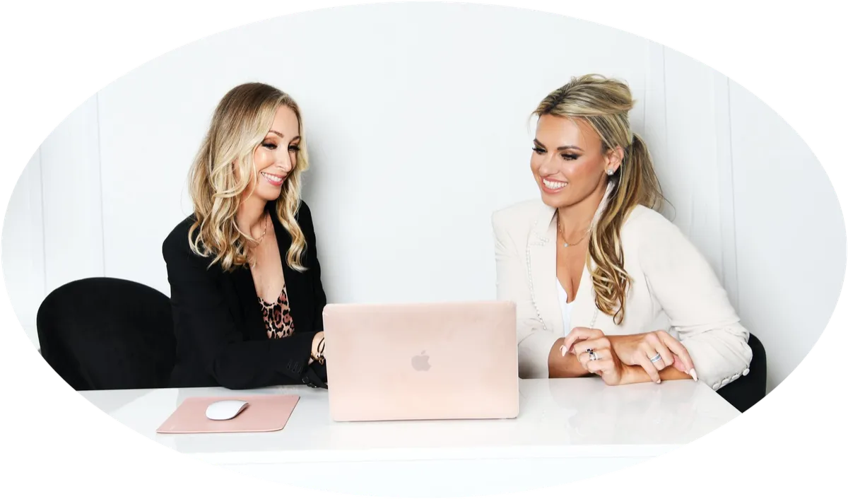 Hallie and Holly of The Chief Code reviewing a match together on a laptop