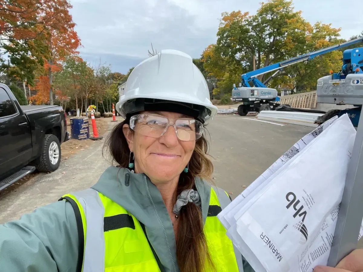 For Seasons Landscape Design/Build Owner Lauren Lautner and project manager reviewing construction plans on a residential job site in Marblehead, MA.