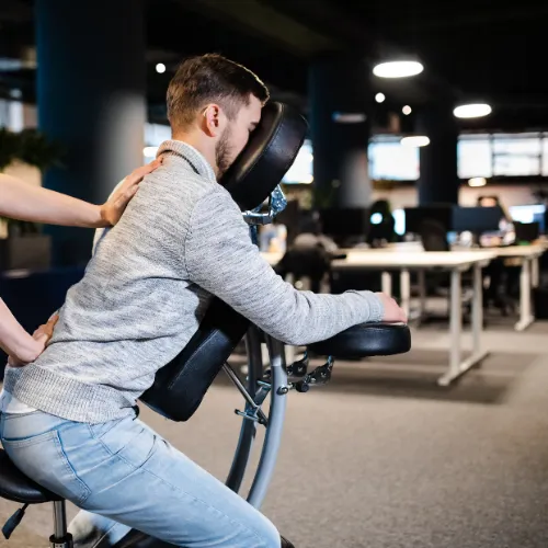 man receiving chair massage at work.