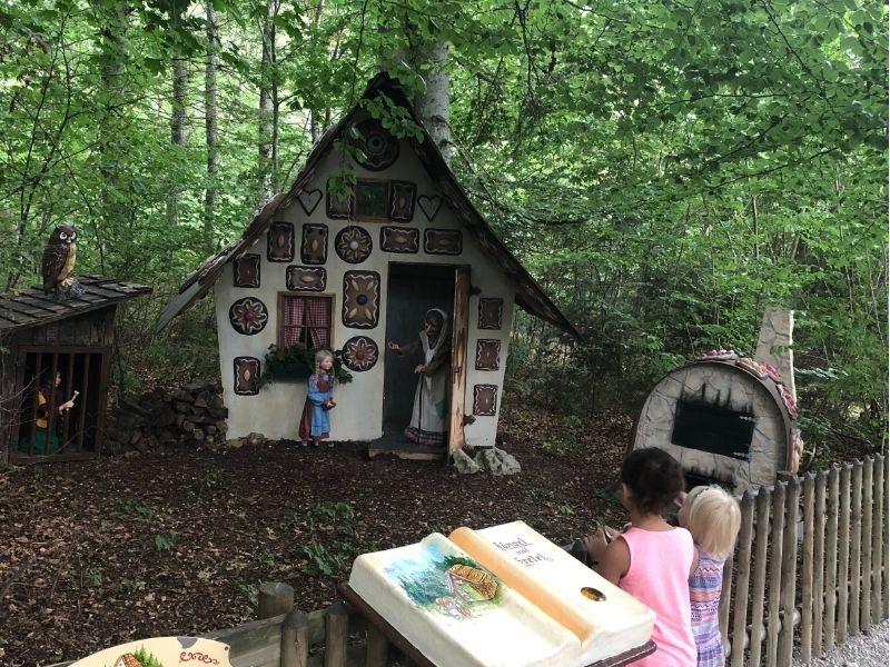 Kids exploring a rebuilt Hansel and Gretel display at a fairytale park in Germany during a fun and educational European family trip