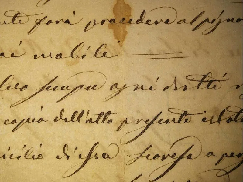 Close-up of centuries-old handwriting on a yellowed paper, reflecting ancestral records and family history research