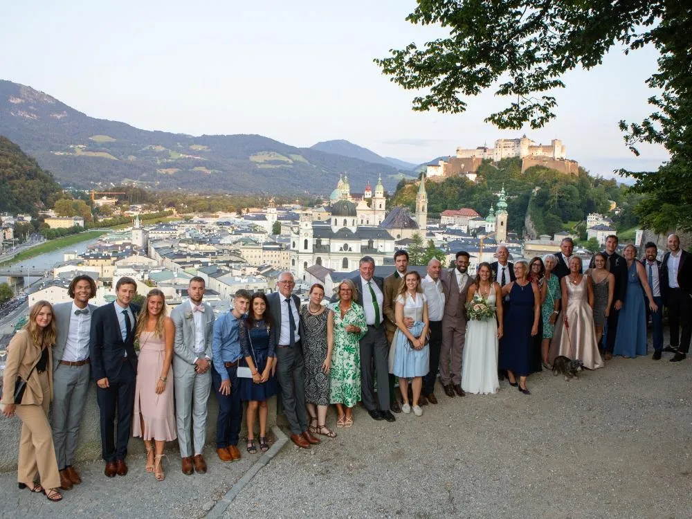 Multigenerational group of travelers with Salzburg in the background during a custom European group tour