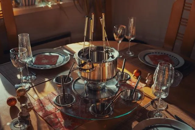 Cozy Swiss dining table with fondue pot in the center, inviting guests to try authentic local food during their visit to Switzerland