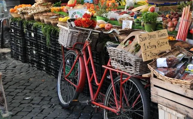Charming farmers market in Europe with a bike parked by a vegetable stand, showcasing fresh local produce from a regional farm