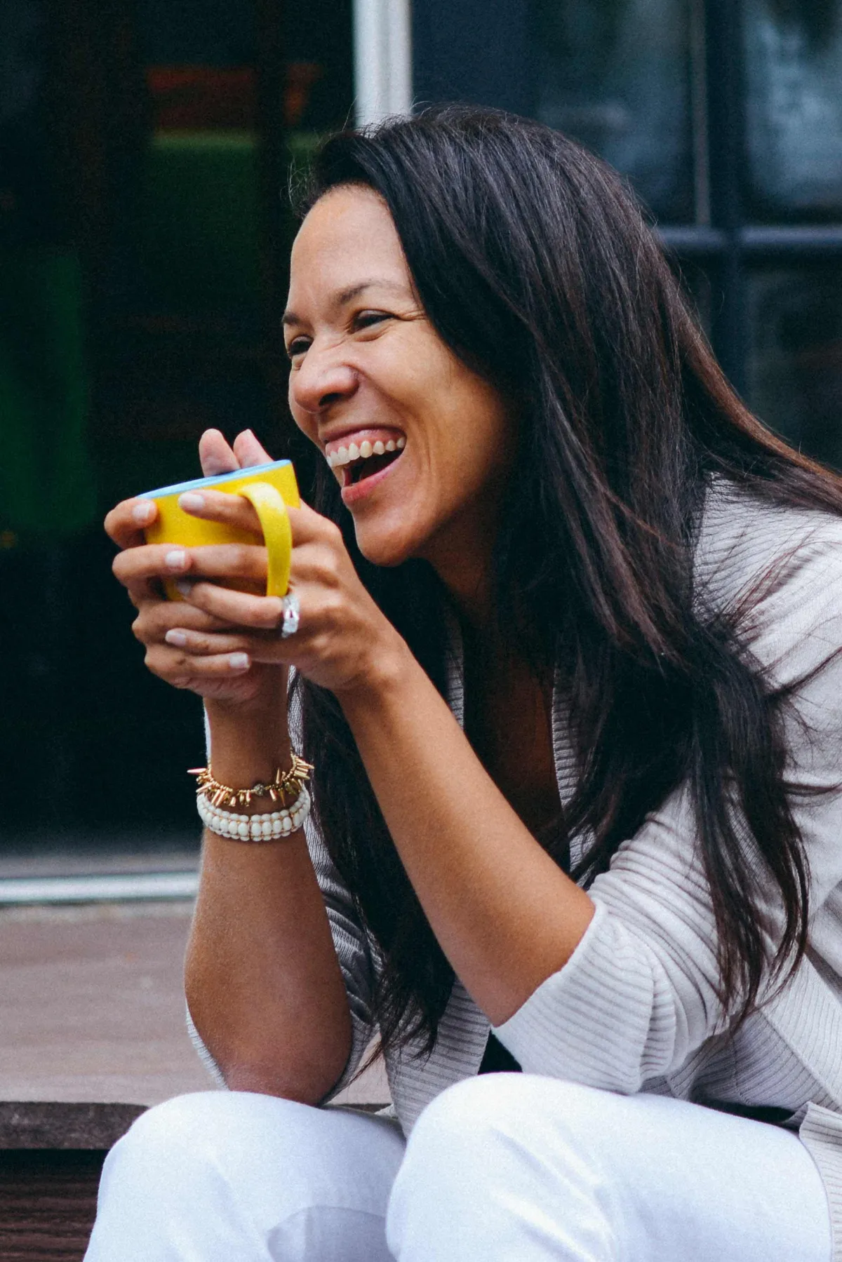 Beautiful stylish woman smiling with a yellow cup of tea