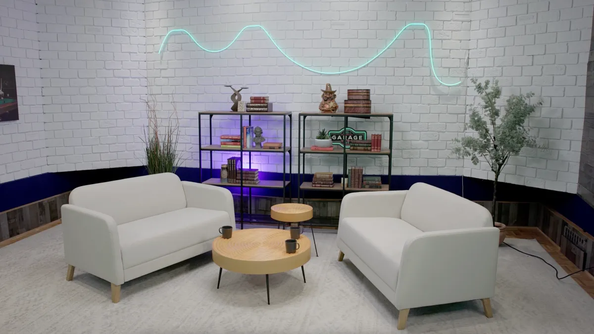 Brick Wall Set with white brick walls, lounge seating, and accent neon lighting at Signature Sound Studios