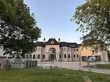 The European-style chateau with construction fence and "FOR SALE" sign suggests a large building available for HVAC projects in the greater toronto area, gta