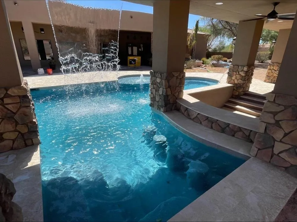 a swimming pool with lounge chairs next to it