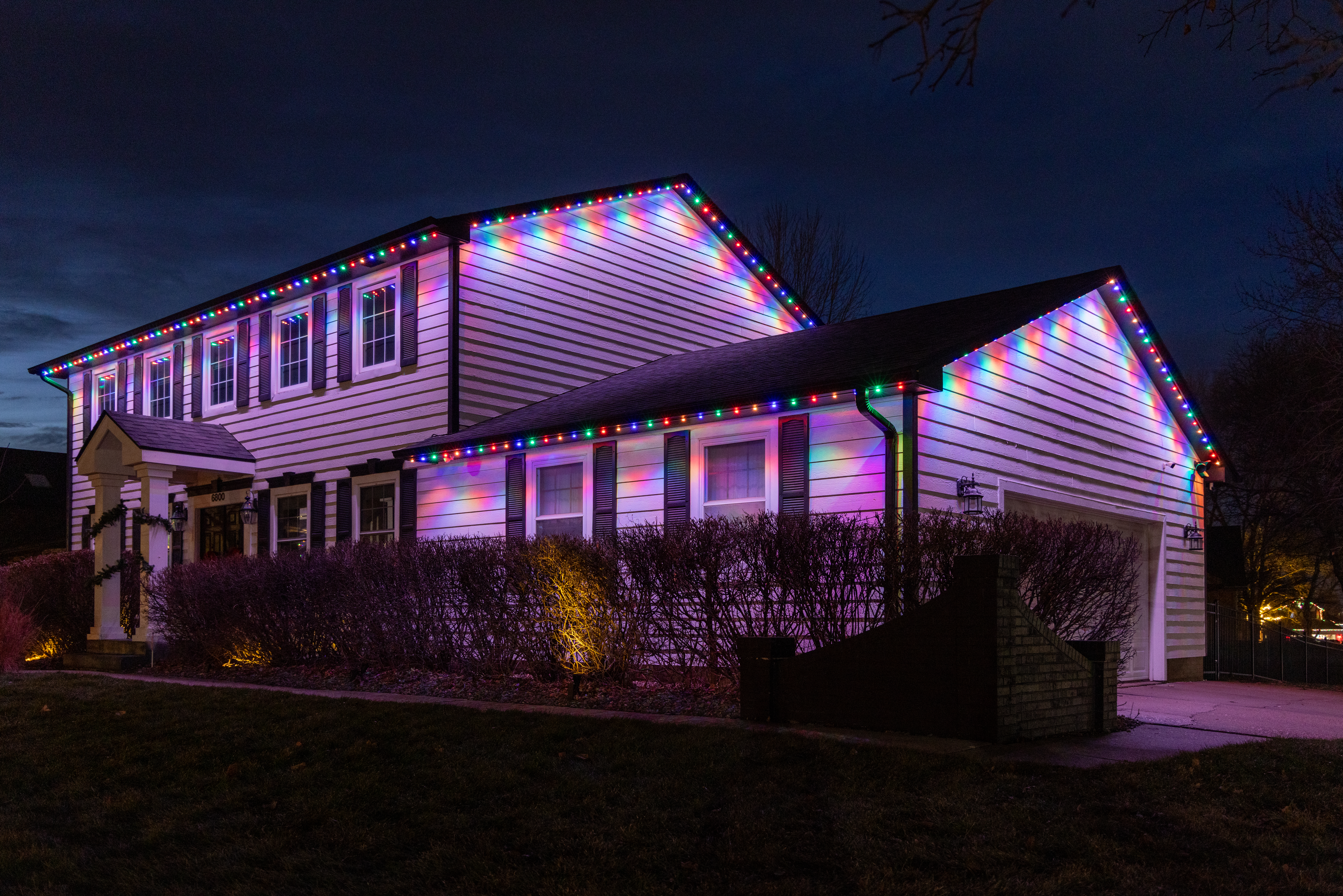 Modern floor lamp with flowers on side table.