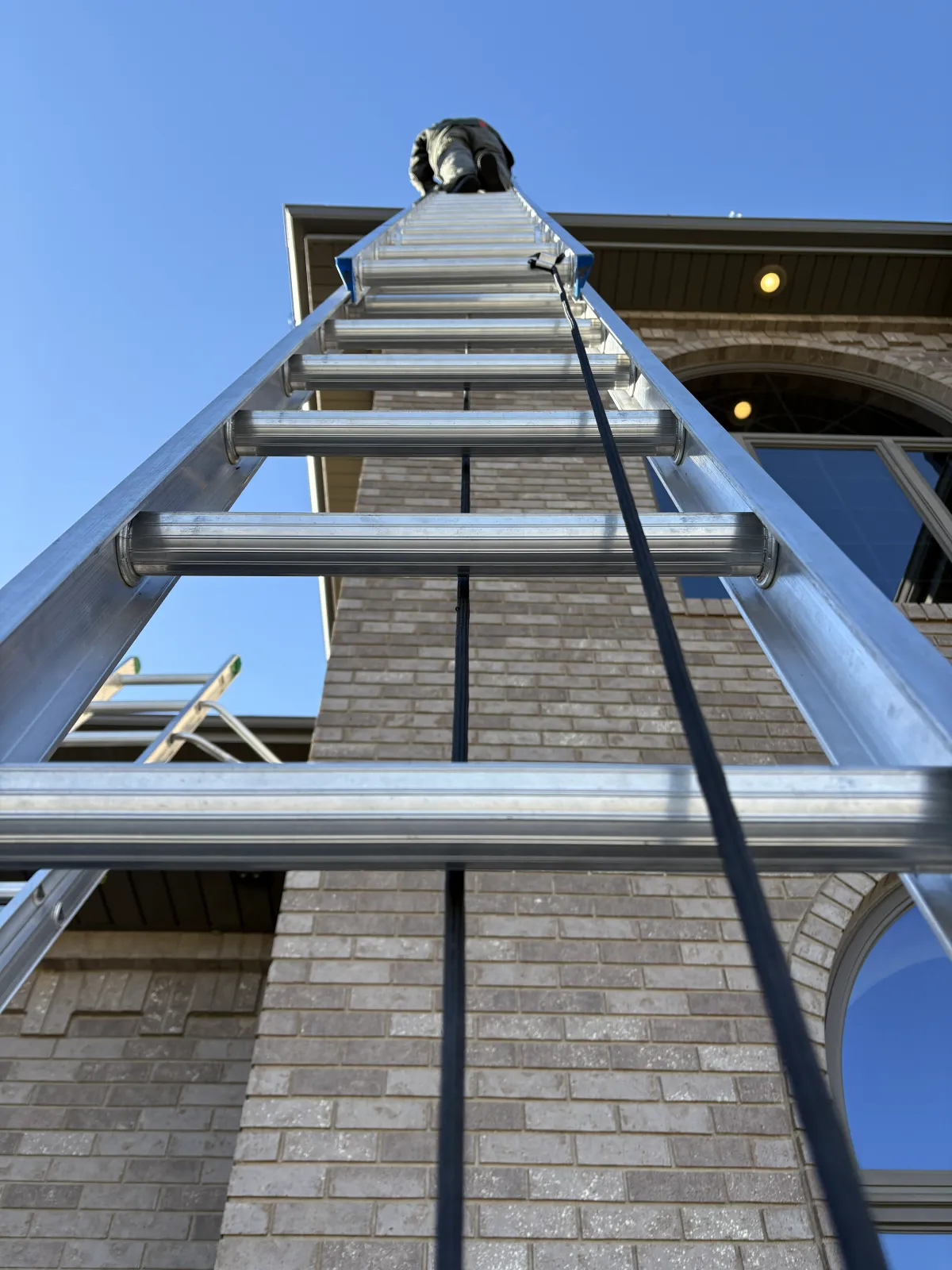 very tall ladder on exterior of home