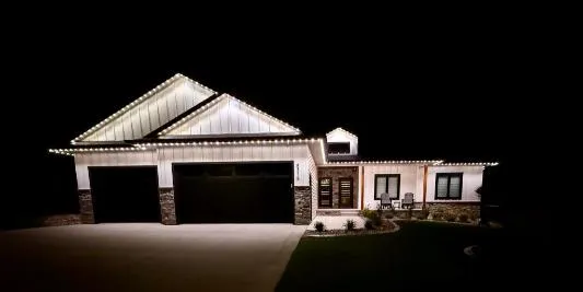 Modern home with warm white permanent lighting glowing at night