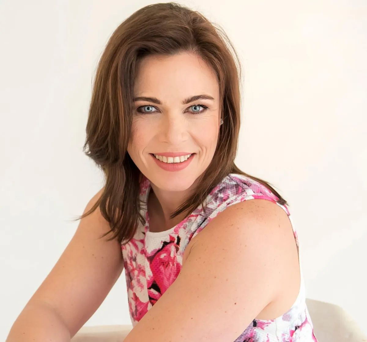 Circular portrait of a confident Black female executive, waist-up, in a navy blazer.