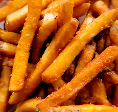 Spicy French fries from The Pizza Block, crispy and perfectly seasoned with a flavorful, spicy batter for an irresistible kick.