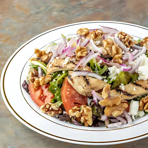 Fresh Spring Salad made with mixed greens, cherry tomatoes, cucumbers, carrots, and a light vinaigrette dressing, perfect for a healthy, refreshing meal.