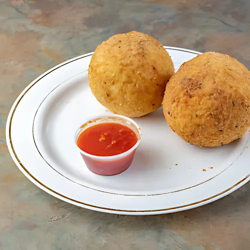 Crispy rice balls filled with savory ingredients, lightly breaded and fried to golden perfection, served as a delicious appetizer or snack.