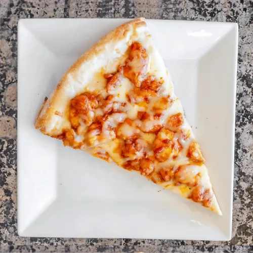 A delicious slice of cheese pizza served on a white plate, showcasing a golden crust and gooey melted cheese.