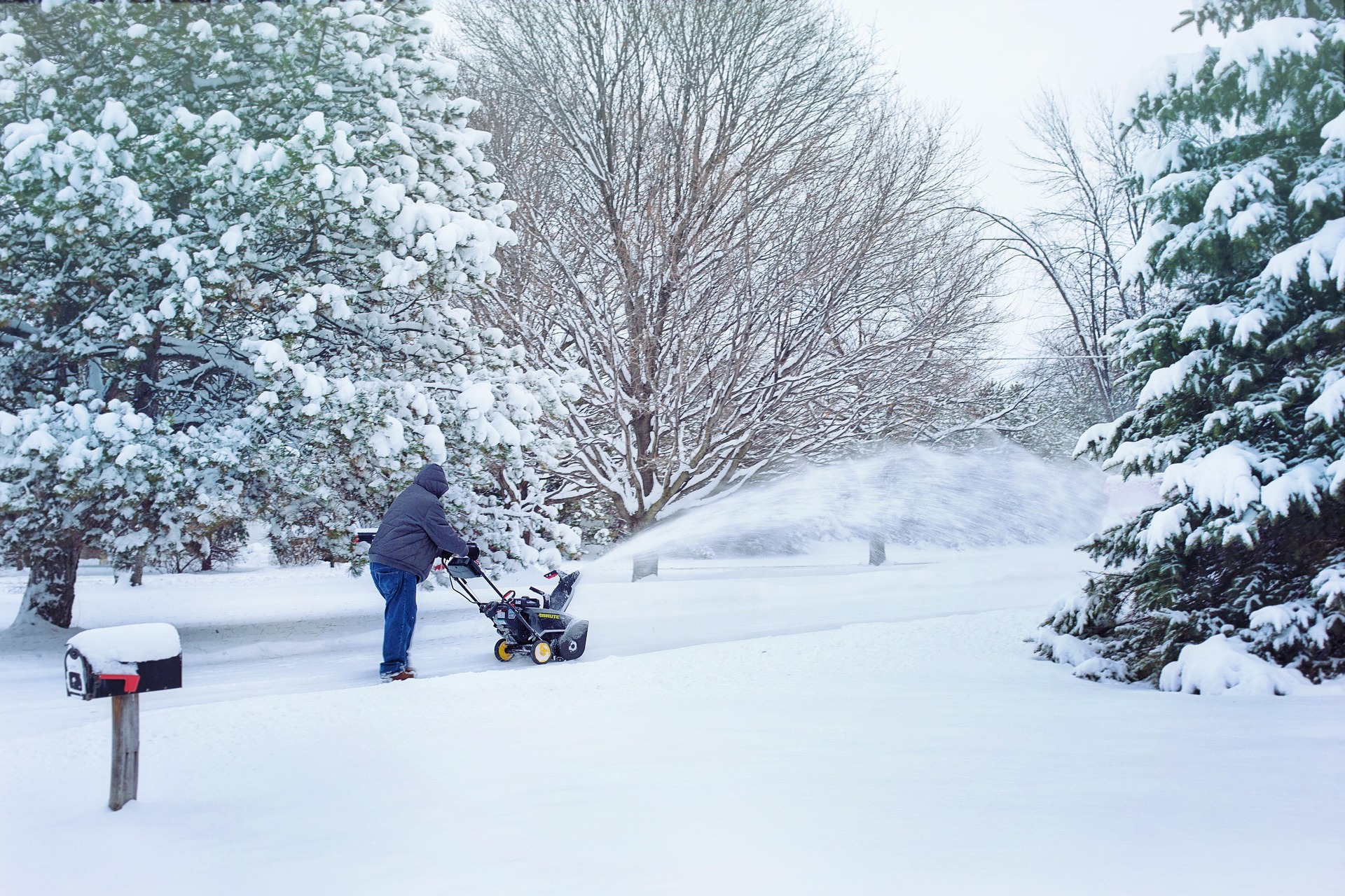 Man Blowing Snow Outside