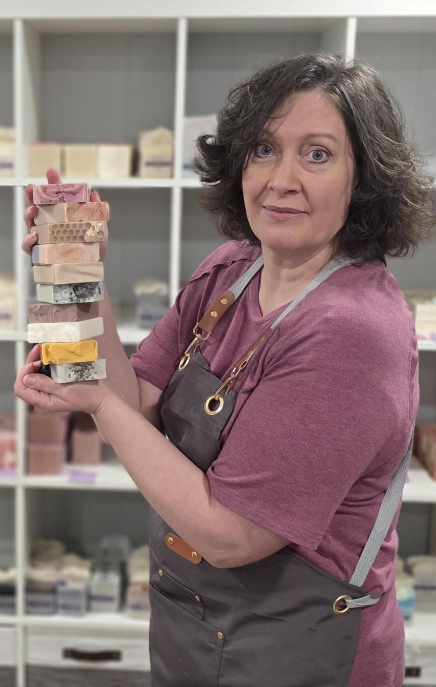 Kim with a stack of different soaps