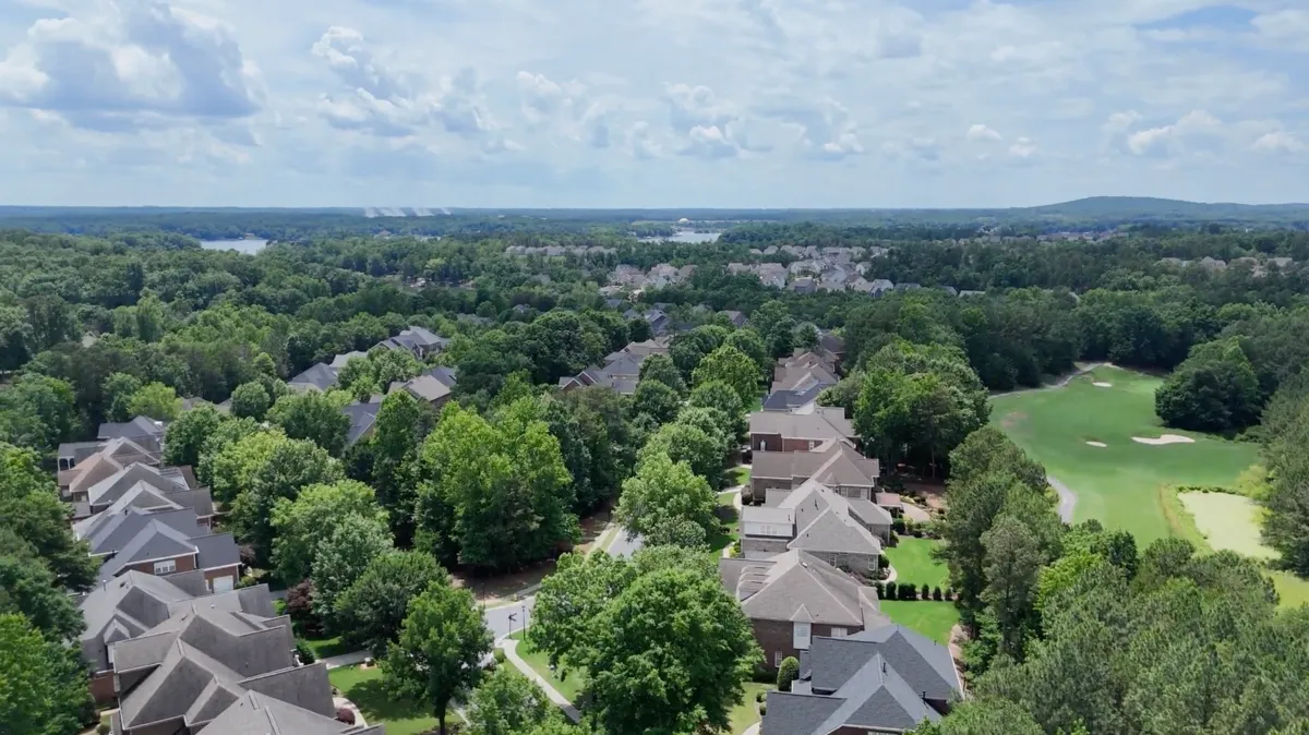 Aerial view of the Crosshaven neighborhood featuring luxury brick homes, tree-lined streets, and golf course views in The Palisades, Charlotte, North Carolina.