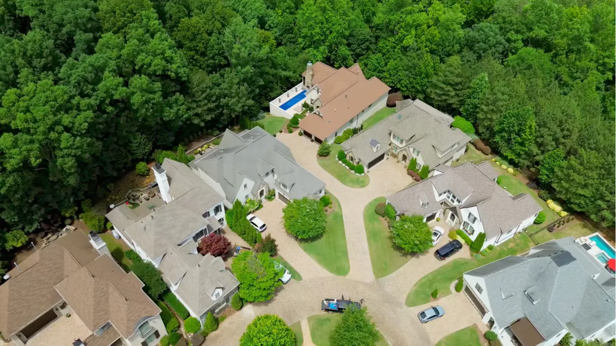 Aerial view of the TreeTops neighborhood at The Palisades in Charlotte, North Carolina, featuring luxury custom homes surrounded by mature trees.
