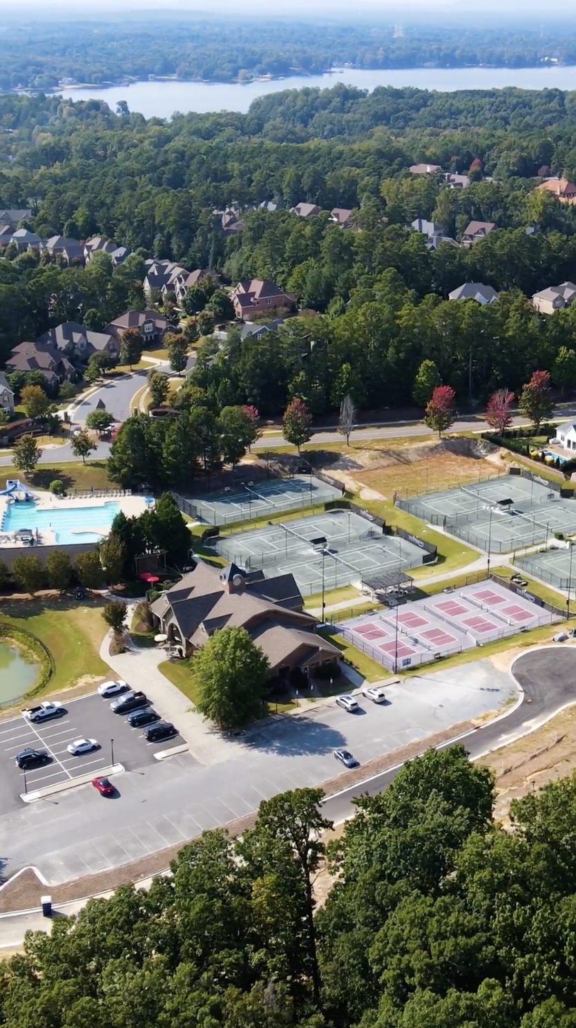 Aerial view of The Palisades Private Residents Club with clubhouse, pool, tennis courts, pickleball courts, and fitness amenities in Charlotte, North Carolina.