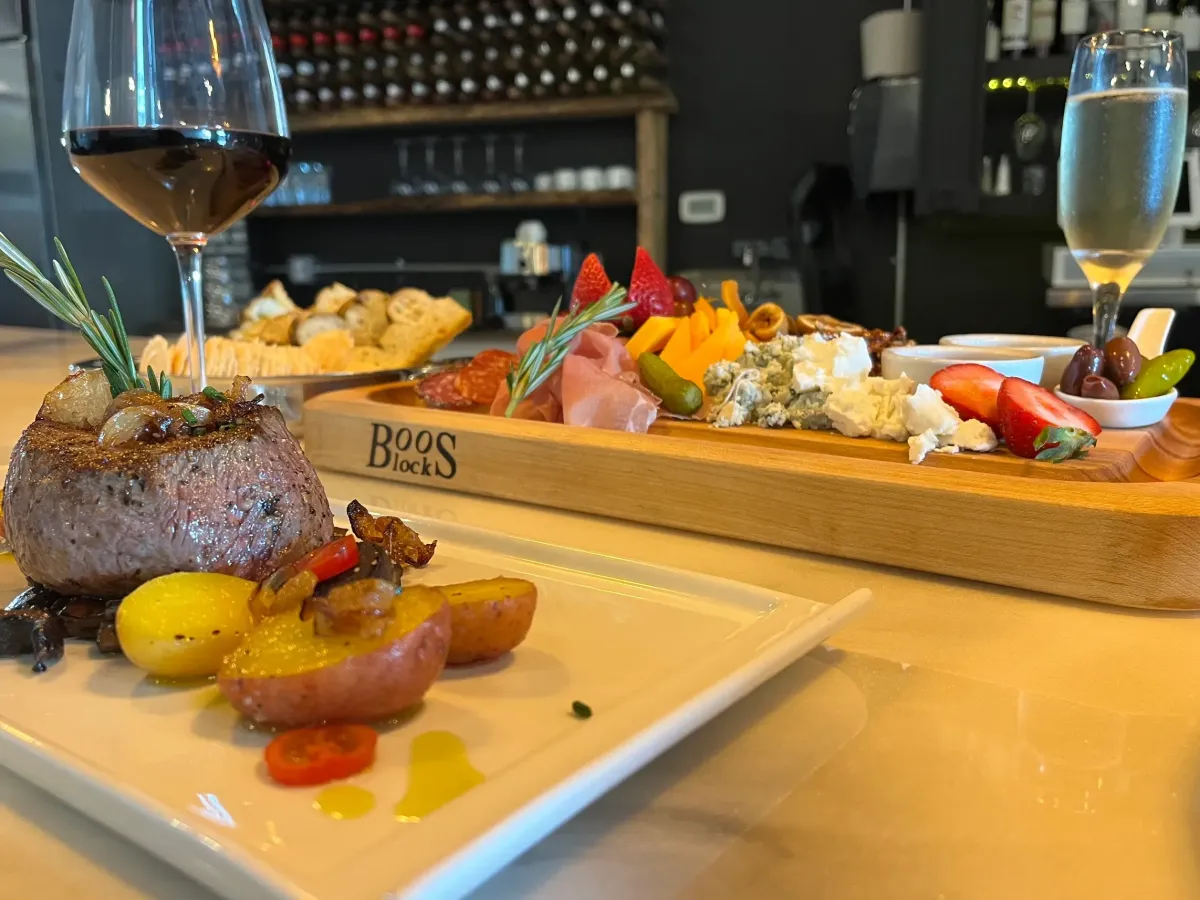 Steak, charcuterie board, and wine at zo.ra Food & Wine in Lake Wylie, a modern American restaurant and wine bar near The Palisades.