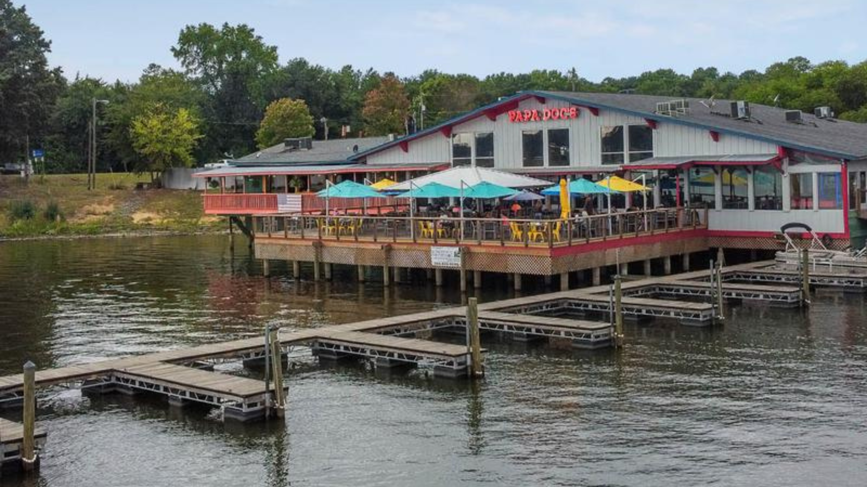 Papa Doc's Shore Club waterfront restaurant on Lake Wylie with outdoor deck seating, boat docks, and lakeside dining near The Palisades.
