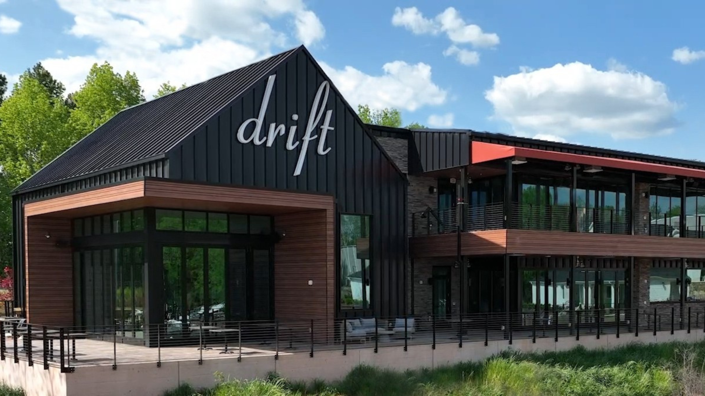 Exterior of Drift on Lake Wylie, a waterfront chophouse offering steaks, seafood, and lakeside dining near The Palisades.