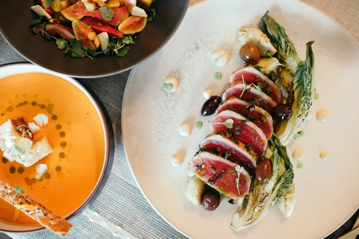 The Speckled Pear in Fort Mill featuring seared tuna, seasonal salad, and creamy soup in an intimate fine dining setting.