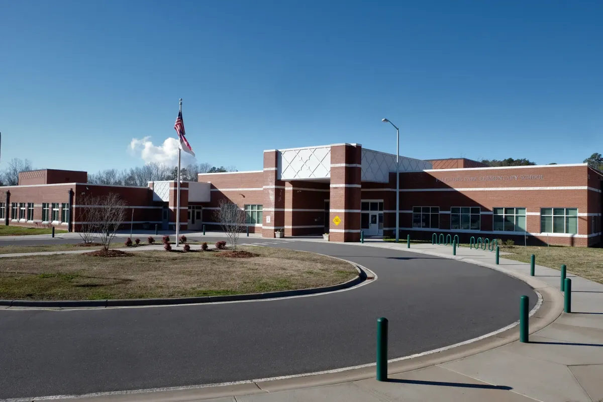 Front entrance of Palisades Park Elementary School in southwest Charlotte with modern brick architecture, landscaped grounds, and the school entrance.