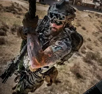 Three adult students receiving pistol fundamentals on a sunlit outdoor lane with a focused instructor demonstrating position and grip.