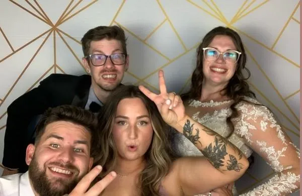 boy sitting on bench while holding a book