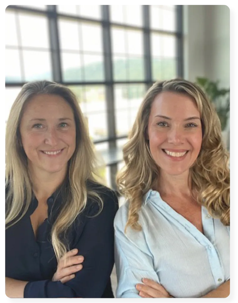 Team of insurance professionals collaborating over strategy charts and digital screens, blue and white office setting