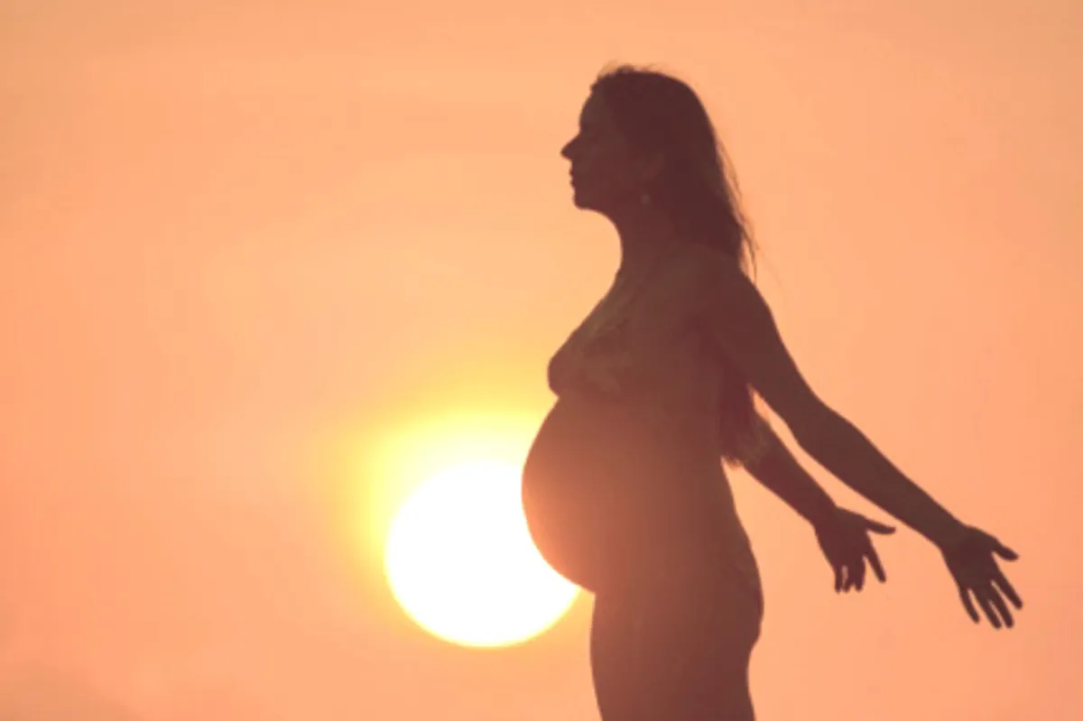 Pregnant woman standing before sunset | Life Transition Support with Lianne Schwartz