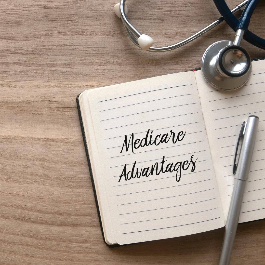 A notebook open to a page that reads "Medicare Advantages.