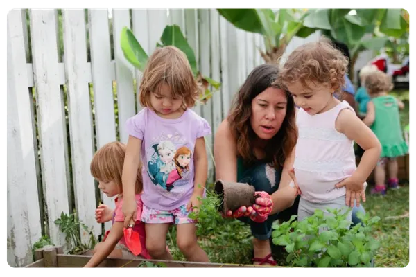 Children planting in outdoor garden at The Nurtury Montessori classroom