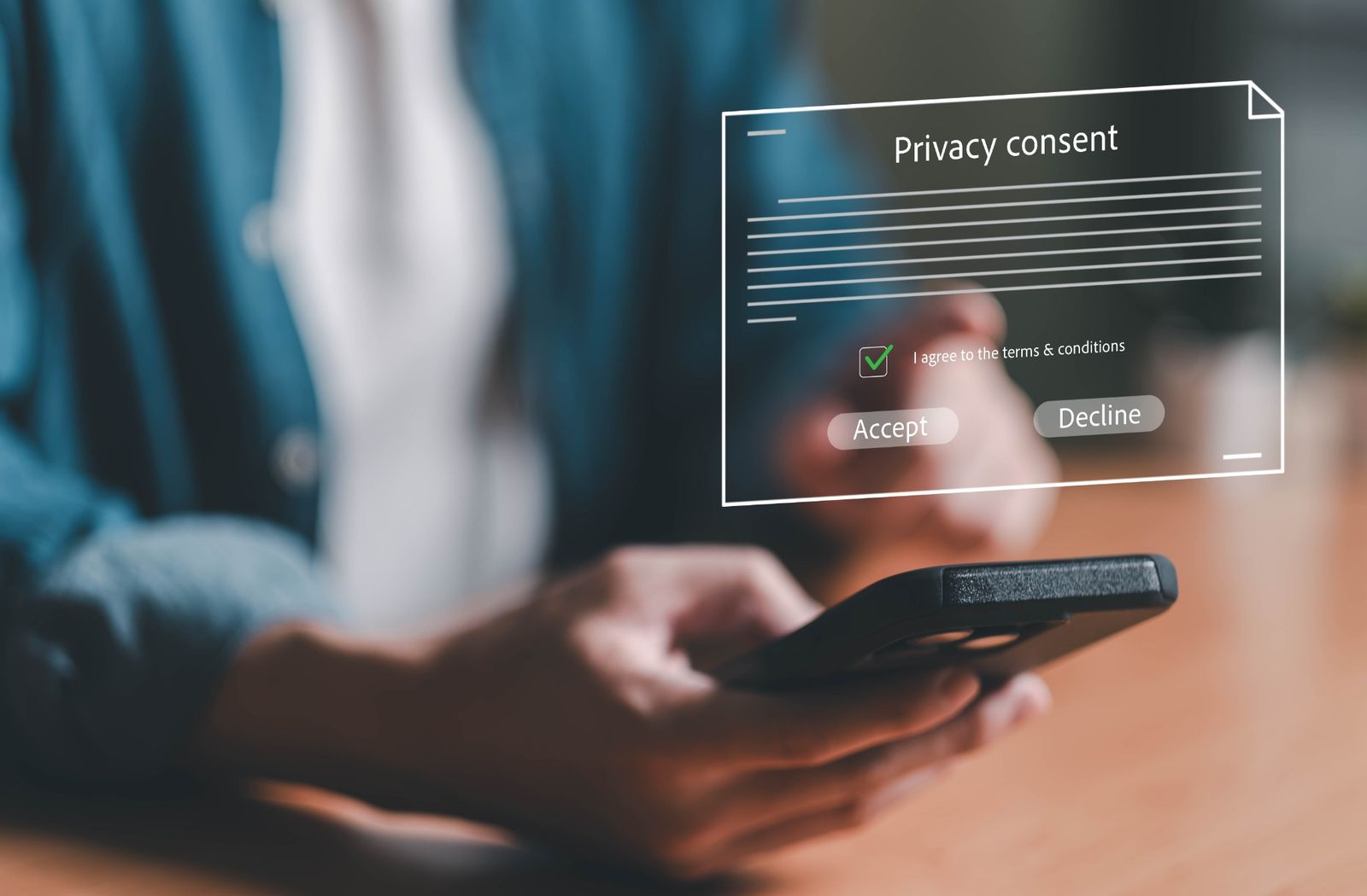 Person using a smartphone with a privacy consent form overlay showing accept and decline options.